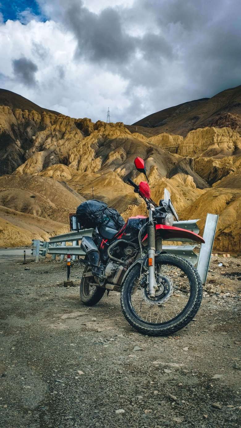 A motorcycle parked on the side of a road in the mountains